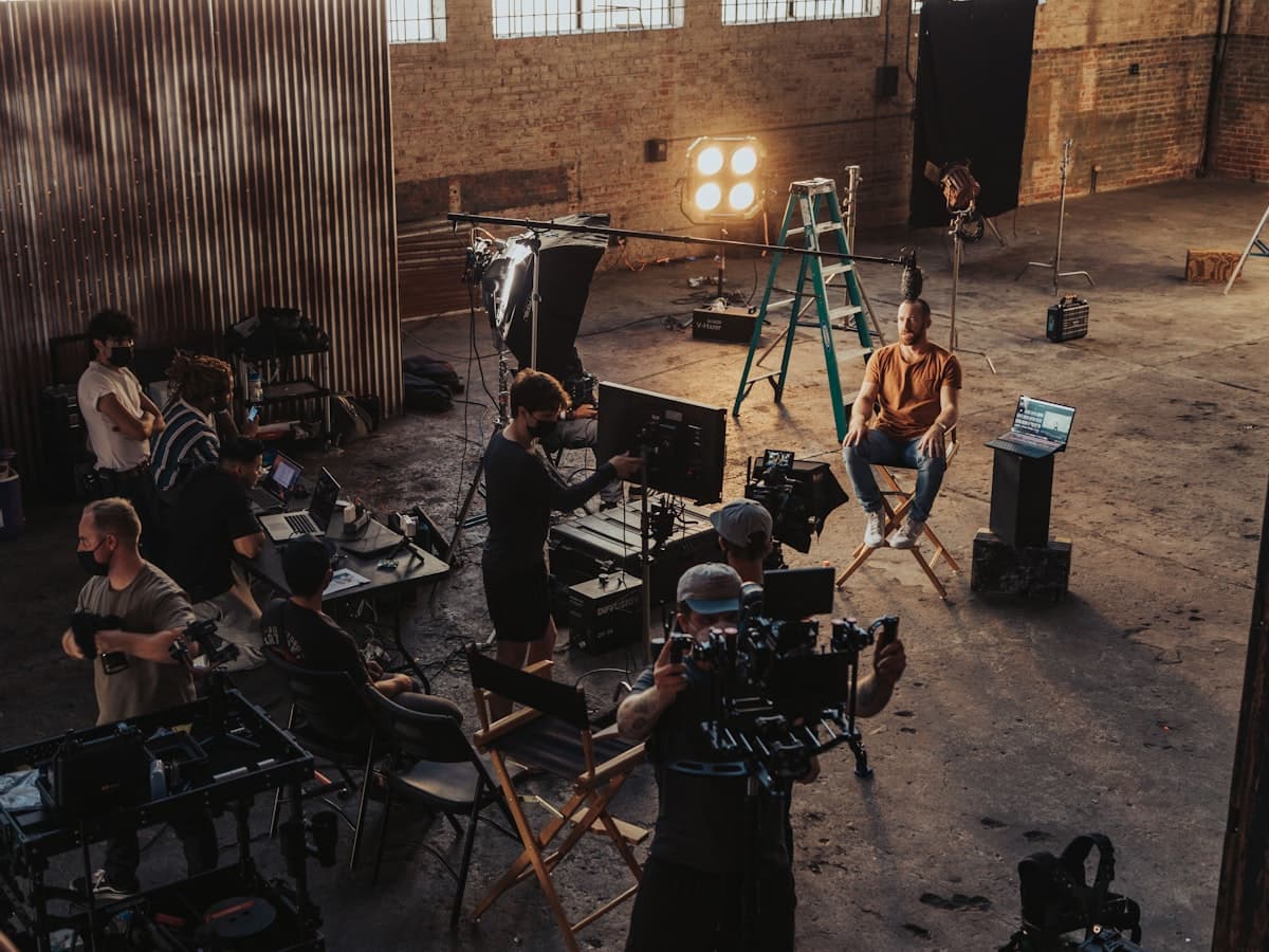 A small crew setting up a camera for a video shoot